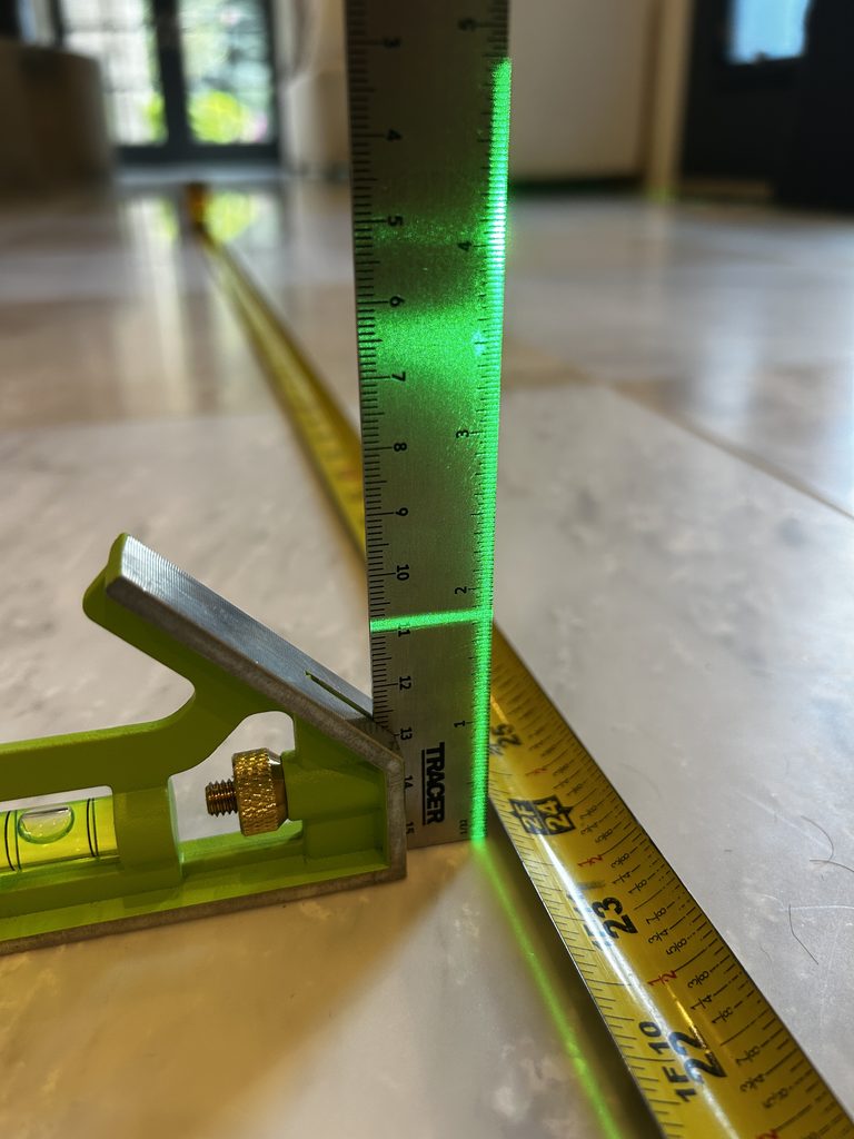 Floor flatness Measurement during natural stone flooring inspection.
